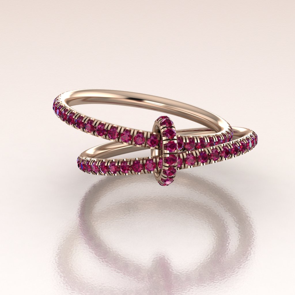 two luxury rose gold eternity bands with red rubies linked by a rose gold ruby loop