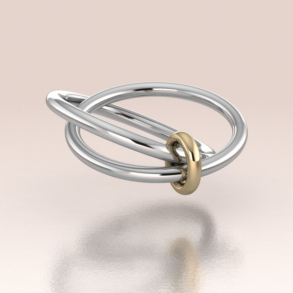 round sterling silver bands linked by a yellow gold ring