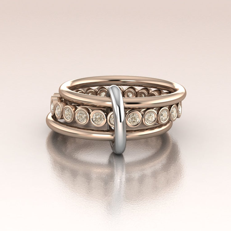 Two rose gold rings with diamond accents on a light beige background