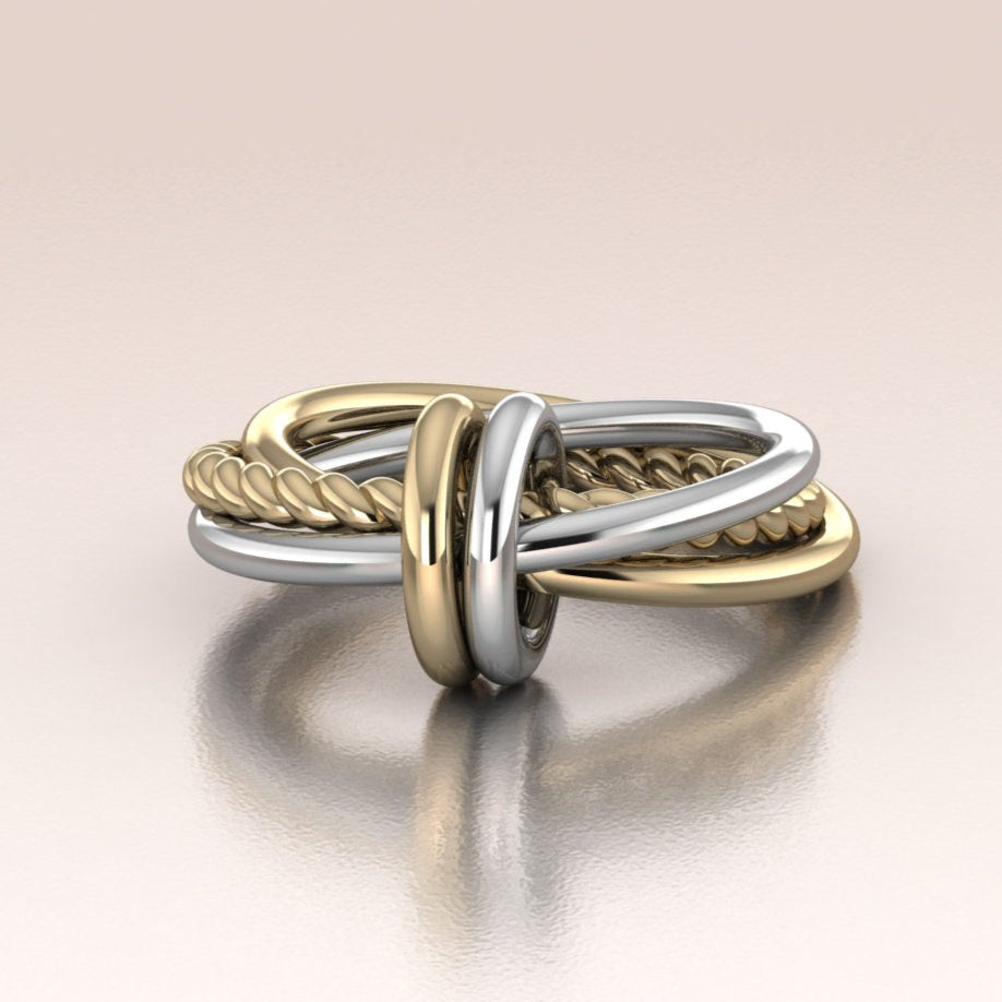 Two-toned yellow gold and white gold ring on a light background