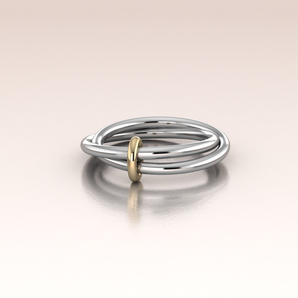 round sterling silver bands linked by a yellow gold ring multi rings