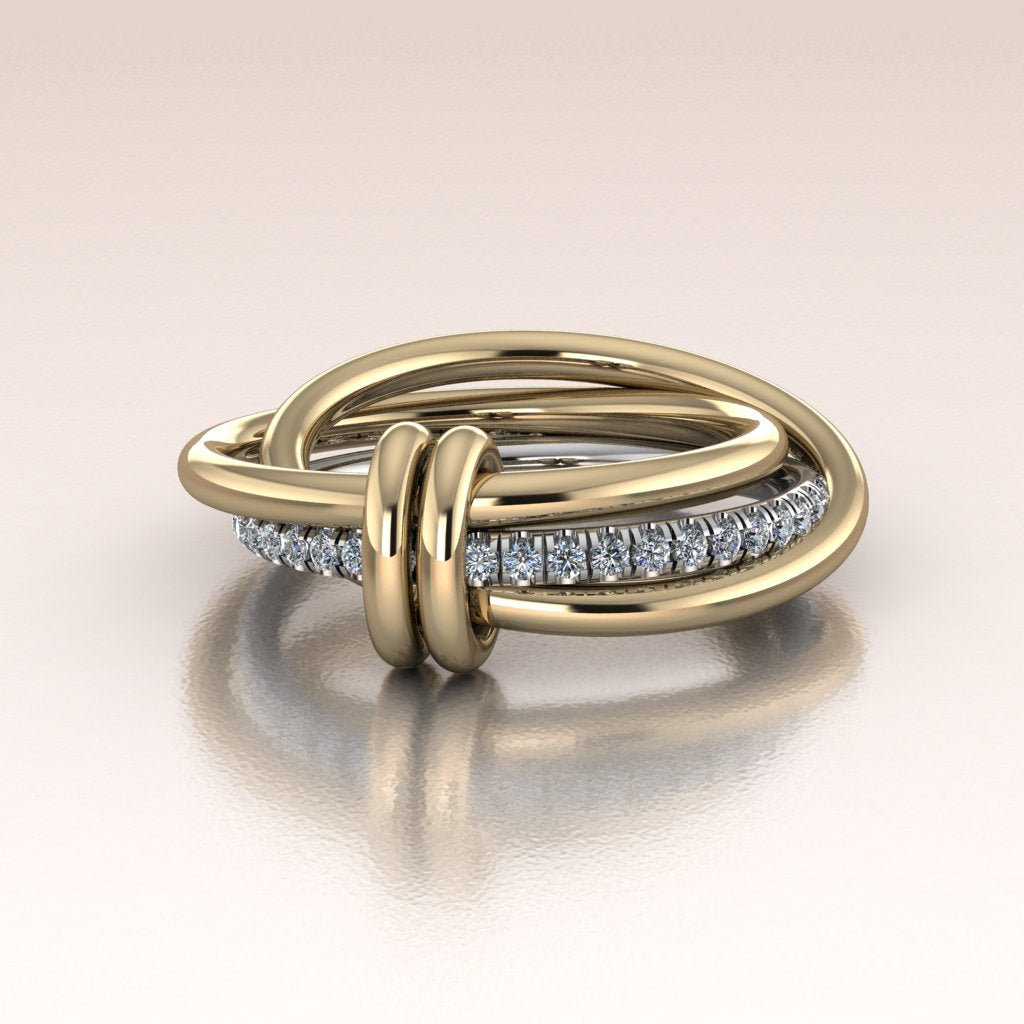 14k yellow and white gold ring with interlocking bands and pave diamonds