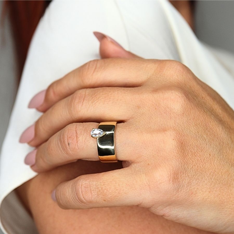 14k gold wide band with pear shape sapphire